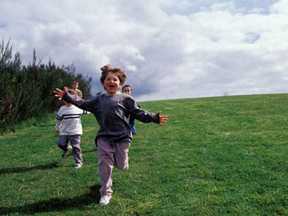 Kids running on a field of grass